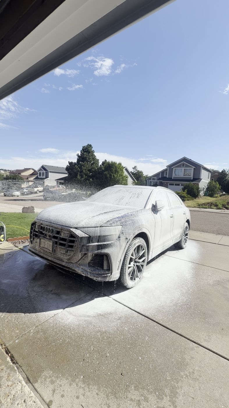 BMW covered in foam during a mobile wash